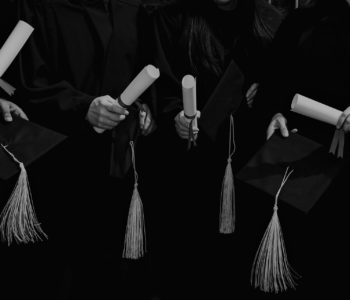 four-grad-students-caps-and-diplomas four-grad-students-caps-and-diplomas